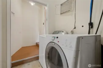 Laundry area on the original side with a door leading to the back yard