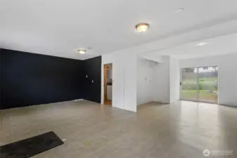 Large main level flex room on the 2nd side. Exterior doors in the front and back. Use as an office, bonus room or bedroom.