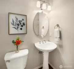 Main floor half bath with a pedestal sink.