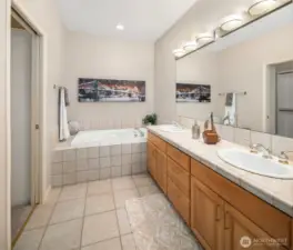 Primary bath with a soaking tub, dual sink vanity, and a separate shower.