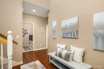 Front entry with beautiful hardwood floors that flow through the hallway and into the kitchen.