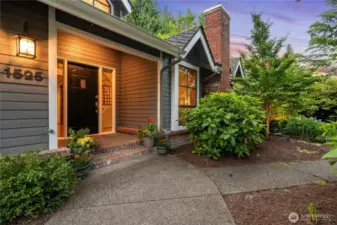mature landscaping to covered porch - refurbished brick chimney
