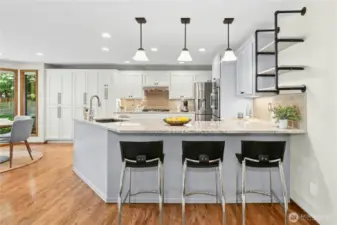 pendant lighting over breakfast bar, newer gas cooktop, bosch DW in updated kitchen