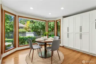 dining nook surrounded a wall of stoage and windows looking out to lush landscapes