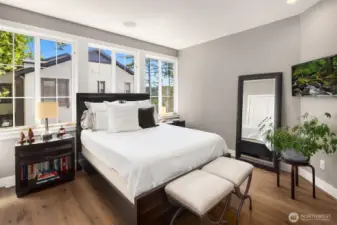 The spacious primary suite is filled with natural light, creating a bright and inviting retreat.
