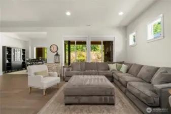 The generous great room looks out over the beautiful backyard. Remote powered custom window coverings in both rooms!