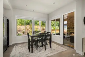 The dining room is bathed in natural light and overlooks the private and beautifully landscaped backyard. Remote powered, custom window coverings.