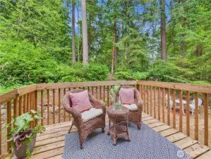 Step out to the back deck directly from the kitchen. With the green area next to the lot you have plenty of privacy.