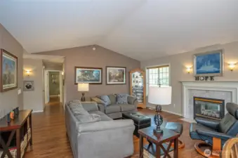 A different perspective of the living room, showing the hallway that leads to the bedrooms.