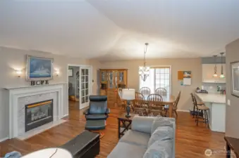 Cozy double-sided fireplace connects the living and family rooms.