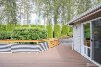 Access the deck from both the primary suite and family room—each sliding door includes a convenient doggy door.