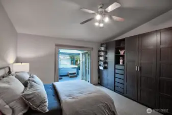 PRIMARY BED WITH FRENCH DOORS OPENS TO THE SALTWATER HOT TUB