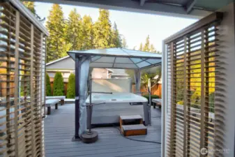 SALT WATER HOT TUB WITH GAZEBO OPENED FRENCH DOORS FROM THE PRIMARY BEDROOM