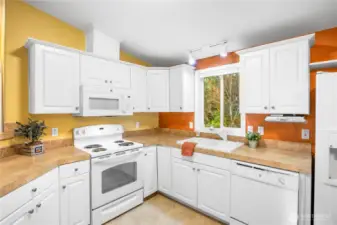 The kitchen overlooks the back yard and deck.