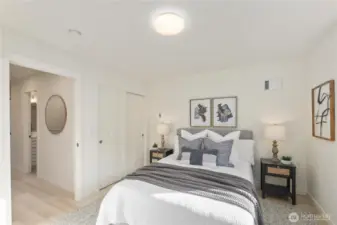 Spacious bedroom layout with neutral tones, closet storage, and access to nearby full bathroom.