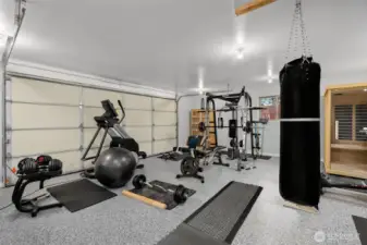 Garage is being used as a private home fitness studio with room for full equipment setup.