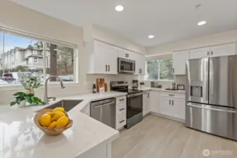 Gorgeously renovated kitchen with new SS appliances, cabinets, quartz countertop and flooring.