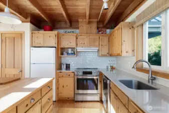 induction stove. Quartz countertops, and custom wood cabinetry.