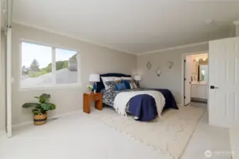 The spacious primary suite offers a serene escape, combining comfort and elegance in every detail. The primary suite is enhanced by plush, soft carpet underfoot, adding an extra layer of warmth and comfort. Every step feels cozy and inviting, making your private retreat even more relaxing and indulgent.