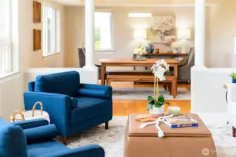 Architectural lines, warm oak hardwood floors, and thoughtfully curated finishes all add to the timeless elegance of the room, while automated Hunter Douglas remote blinds offer instant light control to match the mood.
