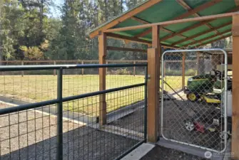 Dog run, covered storage, mower/tractor parking, etc. There is a drive through gate here for access to the fenced back yard from the carport and driveway area.