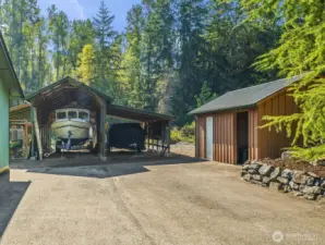 The carport is approx 11'6" wide in the center section, 29' deep and 12'6" tall at the peak in the center. The side section is approx 11'6" wide, 25' deep and 80" to 111" tall. There is also a storage shed to the right of the photo with wall down the middle. One side for storage, the open side is used as a wood shed. This portion of the driveway is well suited to park a very large RV and does have water and power hookups nearby.