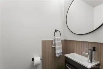 Sink & mirror in the half bath near the living areas.