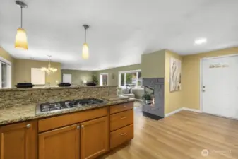 From the kitchen looking to the front door and the fireplace.