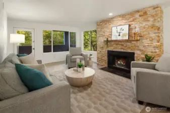The living room with welcoming fireplace (fire added for effect, buyer to verify functionality) and seamless connection to covered deck.