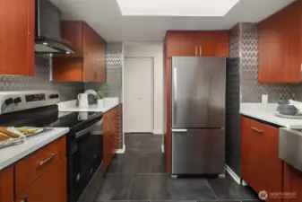 Kitchen leading in to hallway connecting to laundry, bedrooms & bathrooms.
