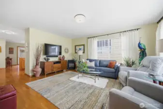 Looking across the spacious living room toward the kitchen and dining area beyond.