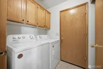 The utility room also has a lot of storage cabinets and opens to the attached 2-vehile garage.