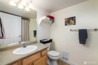 A full guest bath with storage in the vanity.