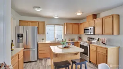 Enjoy newer stainless steel appliances and an island with breakfast bar seating.