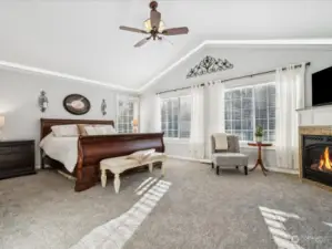 Primary bedroom w/cozy fireplace, creates a relaxing retreat.