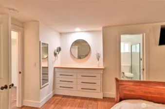 Primary bedroom built in dresser with custom finish work throughout home.