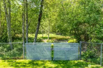 Back gate opens to paved road leading to community dock/beach/cabana/BBQ