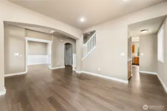 Curved arches, wood wrapped doors & open staircase. Butlers Pantry tucked between the kitchen & flex space.