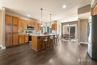 Newer SS appliances, rich wood floors throughout, kitchen island with plenty of prep space, plenty of storage.