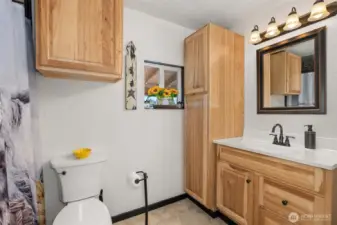 This home’s single bathroom is spacious, inviting, and beautifully decorated with a cozy, modern charm.