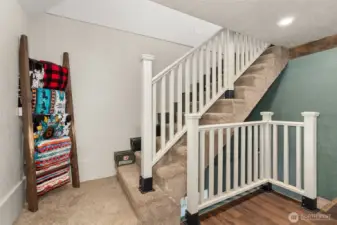 Stairs to primary bedroom, and lower level