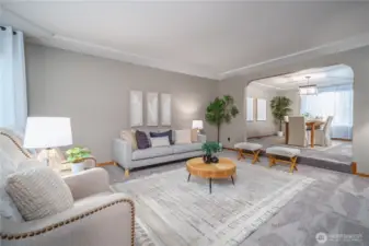 To the left of the foyer is the expansive, elegant formal living room that flows into the dining room.