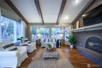 The spacious family room features beamed ceilings and a warm gas fireplace.