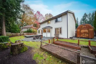 A large side-yard shed is ideal for garden tools, and a firepit area invites summertime s’mores.