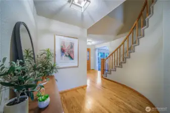 From the family room, head down the hall and up the grand staircase to the four upper-level bedrooms.