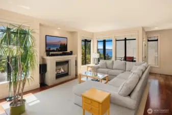 Large living room features the 2nd of 3 gas fireplaces, gorgeous Lake Washington views, a balcony and tons of space!