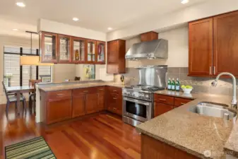 Symetric spaces flank either side of the kitchen, creating a unique flow - one side for informal dining, with a bar for barstools, and the other side the dining room.