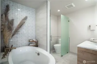 Separate toilet area with privacy glass doors.