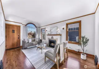 Brimming with character the living room features newly converted gas fireplace and leaded crest window.