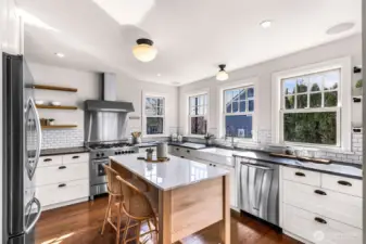 Gourmet kitchen with island (island stays) and door leading to backyard upper composite deck.